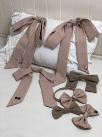 a set of bow ties and a pillow on a bed