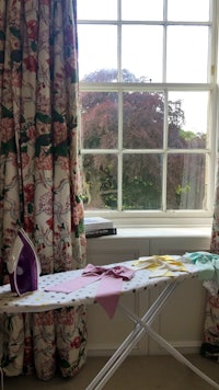 an ironing board in front of a window